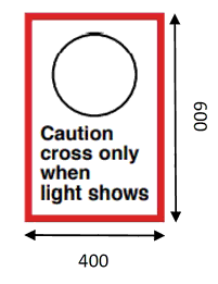 Sign with an outlined traffic light shown with wording that reads “Caution cross only when light shows”