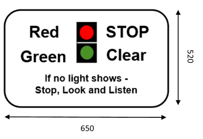 White rectangle sign showing diagram of light signals with wording either side reading: “Red - Stop and Green - Clear. If no light shows - Stop, Look and Listen”