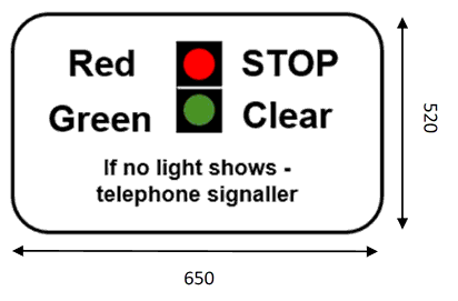 White rectangle sign showing diagram of light signals with wording either side reading: “Red - Stop and Green - Clear. If no light shows – telephone signaller”